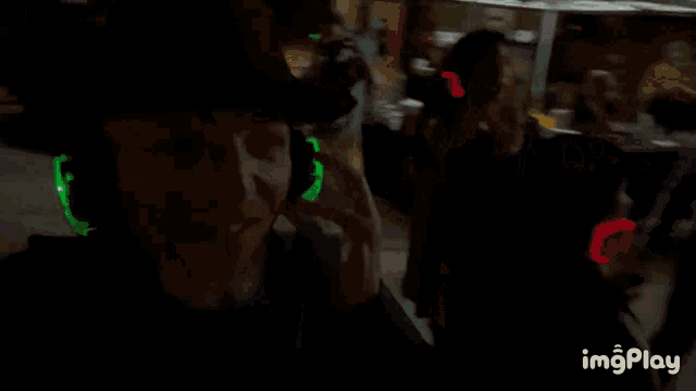 a person wearing glow in the dark headphones and a hat with imgplay written on the bottom