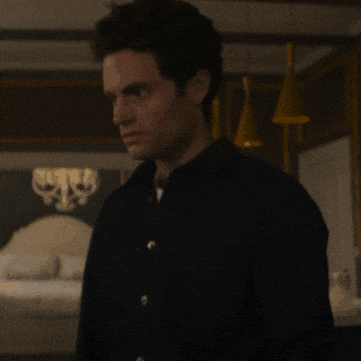 a man in a black shirt is standing in a room