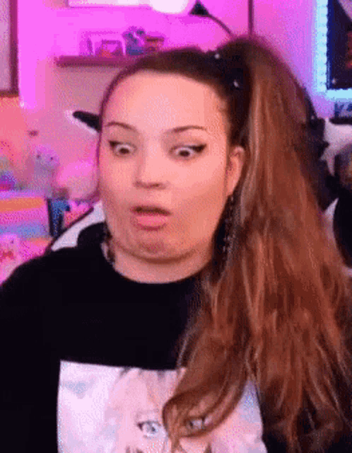 a woman with long hair and a ponytail is making a surprised face .