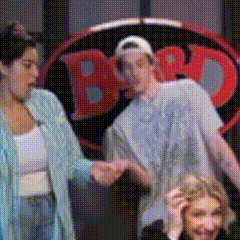 a blurry picture of people holding hands in front of a bbd sign