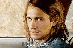 a man with long hair is sitting in the back seat of a car and says `` hell yeah '' .