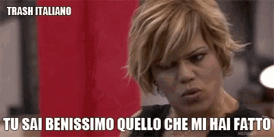 a woman with short blonde hair is making a funny face with the words trash italiano on the bottom .