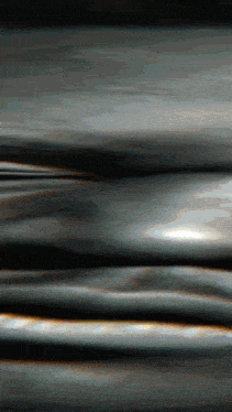 a close up of a metal surface with a few lines