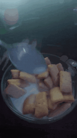 a bowl of cereal is being poured into a spoon
