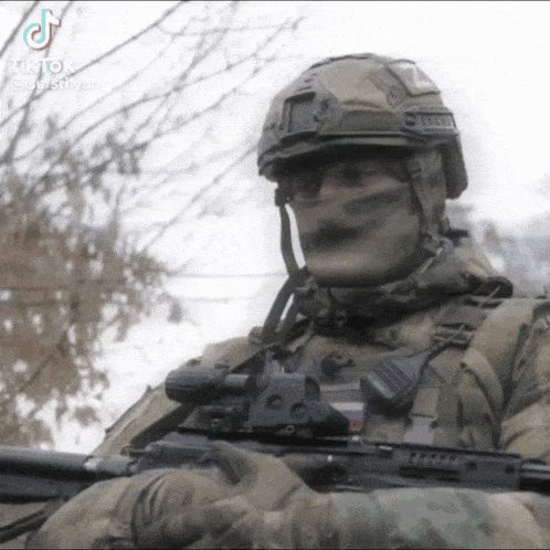 a soldier wearing a helmet and holding a gun with tiktok written on the bottom