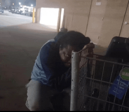 a man is leaning against a shopping cart that has a sticker on it that says real