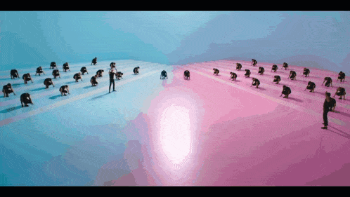 a man stands in the middle of a pink and blue field of people