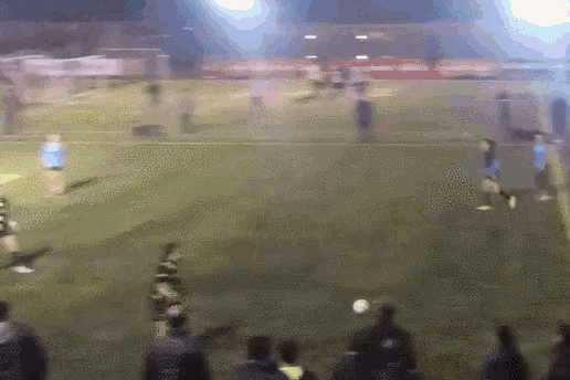 a blurry picture of a soccer game being played on a field