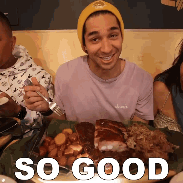 a man in a purple shirt is holding a fork in front of a plate of food with the words so good below him