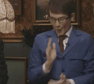 a man in a blue suit and tie is dancing in front of a picture .