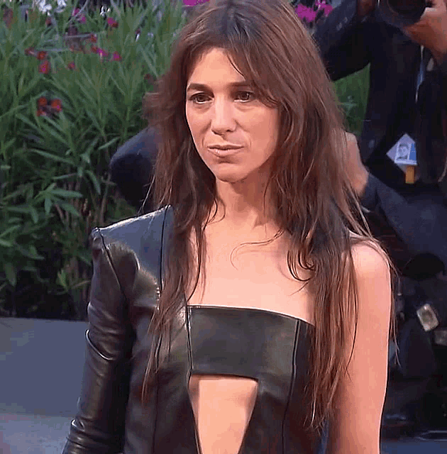 a woman wearing a black leather top has a badge that says ' a. ' on it