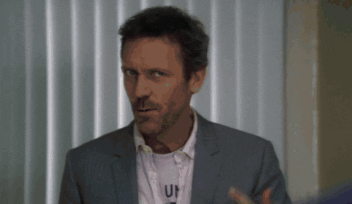 a man in a suit has a lanyard around his neck that says un