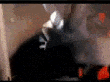 a blurry picture of a person 's face with a red light in the background .