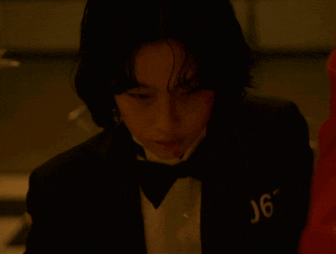 a man in a tuxedo and bow tie has the number j67 on his chest