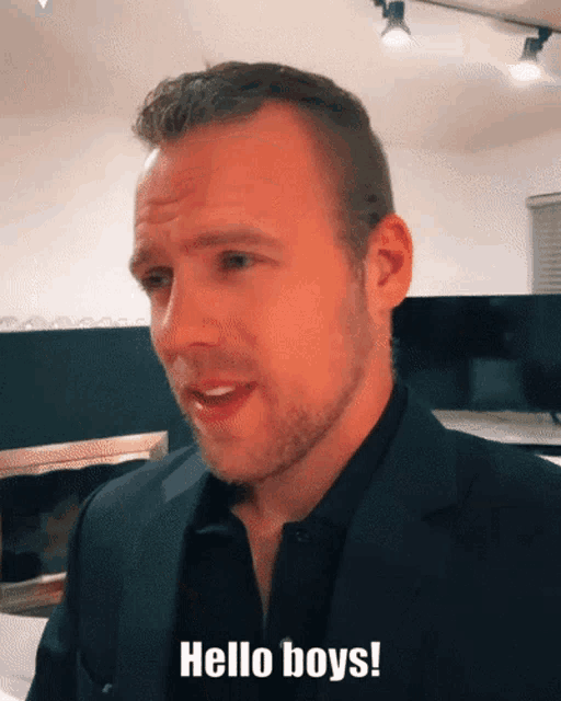 a man in a suit says hello boys on his face