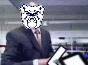a man in a suit and tie has a picture of a bulldog on his head