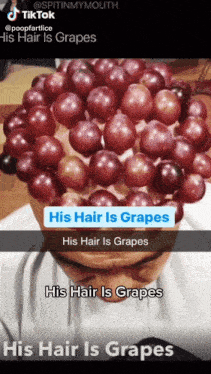 a person with a bunch of grapes on their head with a caption that says his hair is grapes