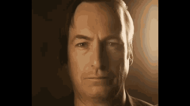 a close up of a man 's face with his eyes closed