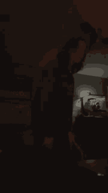 a person is standing in a dark room with a blue light on the floor