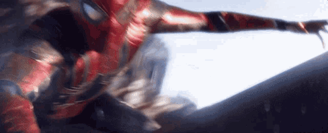 a close up of a person in a superhero costume flying in the air .