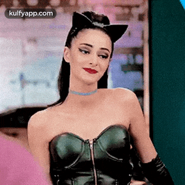 a woman is wearing a cat costume and a choker .