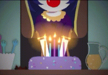 a clown is blowing out candles on a birthday cake