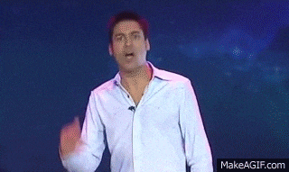 a man is dancing on a stage with makeagif.com in the corner