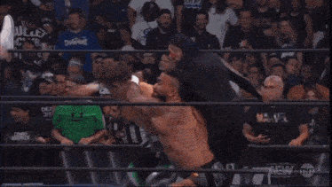 a wrestling ring with a sign that says aew