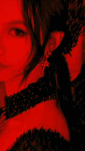a woman is wearing a black dress and a crown on her head