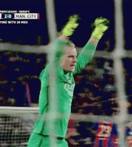 a soccer player in a green jersey is raising his arms in the air during a game between man city and fc barcelona