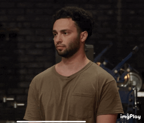 a man with a beard wearing a t-shirt with imgplay at the bottom