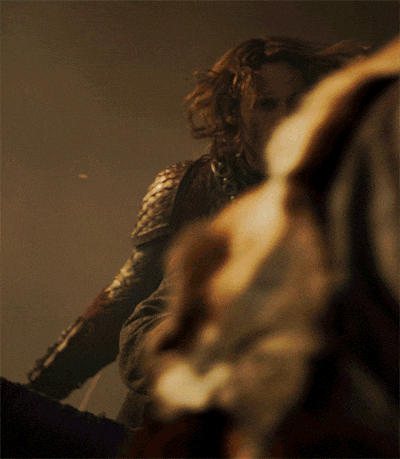 a man in armor is holding a man in a blanket
