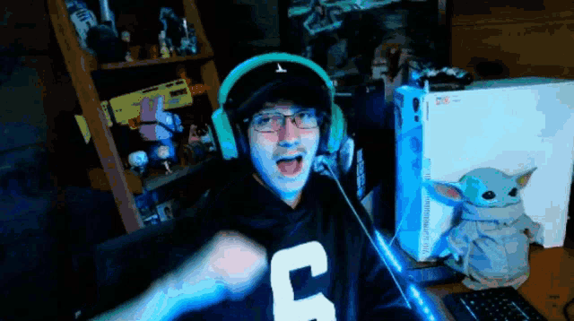 a man wearing headphones and a shirt that says c on it