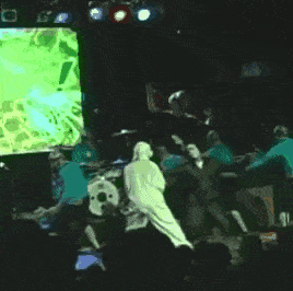 a group of people are playing instruments on a stage in front of a large screen