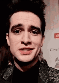 a close up of a man 's face with a slight smile on it .