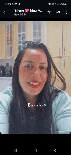 a woman 's face is displayed on a phone screen with the words bom dia below her