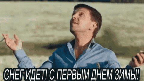 a man in a blue shirt is smoking a cigarette and holding a cigarette .