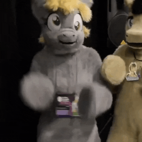 a person in a pony mascot costume is standing next to another person in a horse mascot costume .