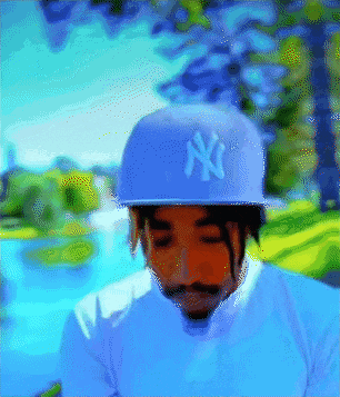 a man wearing a ny hat is looking down