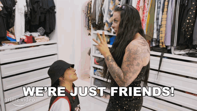 two women in a closet with the words " we 're just friends "
