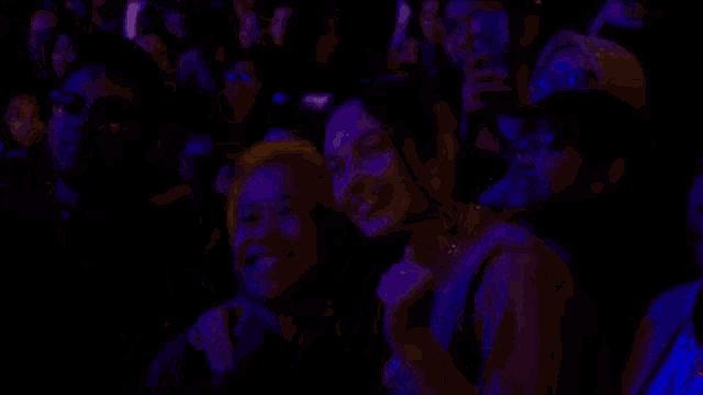 a group of people are sitting in a dark room