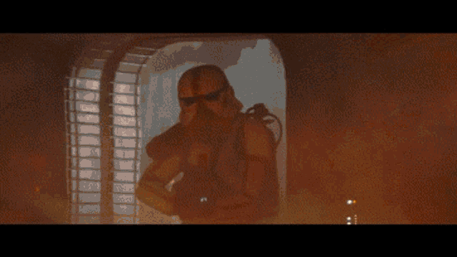 a storm trooper is standing in front of a window in a room