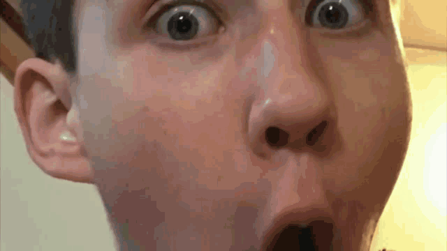 a close up of a person 's face with their mouth open .