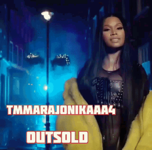 a woman in a yellow jacket is standing in front of a street light and says outsold .