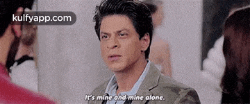 a man in a suit is talking to a woman in a crowded room .