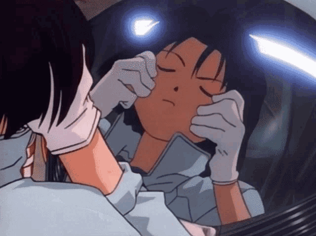 a person wearing white gloves is touching another person 's face with their hands