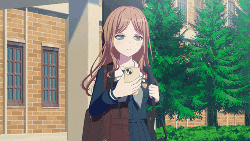 a girl in a school uniform holds a cell phone in front of a brick building