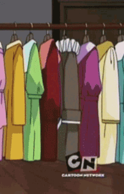 a bunch of clothes are hanging on a rack with cn cartoon network written on the bottom