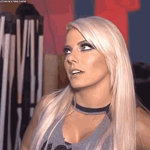 a woman with blonde hair and a choker on her neck is looking at the camera .