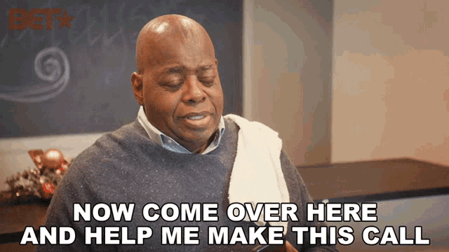 a man with a towel around his neck says now come over here and help me make this call